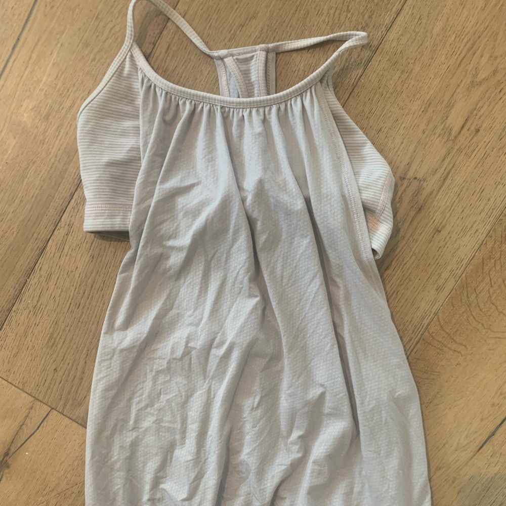 This is a cream colored lululemon tank top with a built in sports bra.